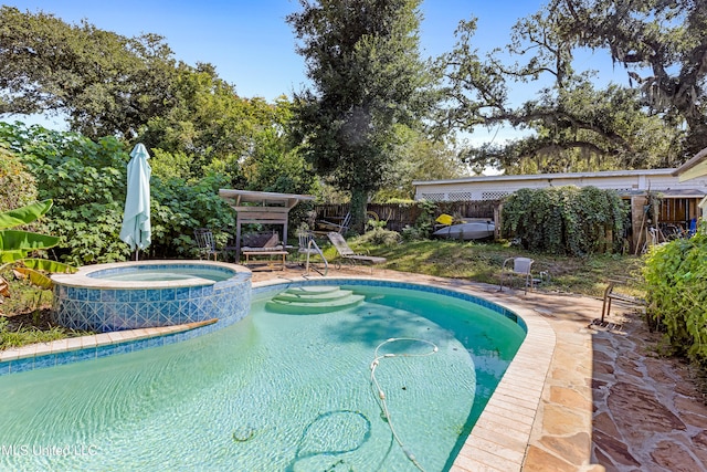 view of pool with an in ground hot tub and a patio