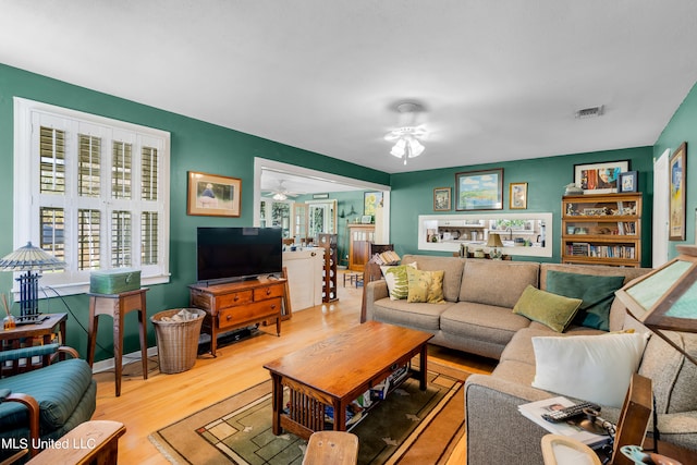 living room with hardwood / wood-style floors and ceiling fan