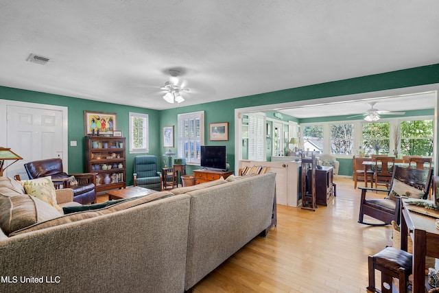 living room with a healthy amount of sunlight, light wood-type flooring, and ceiling fan