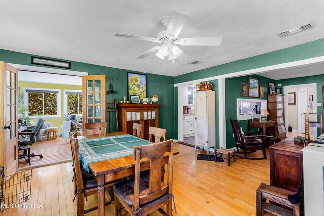 dining area with french doors, light hardwood / wood-style floors, and ceiling fan