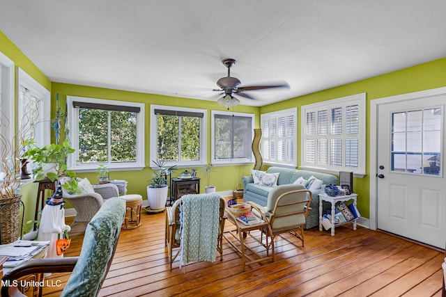 sunroom featuring ceiling fan