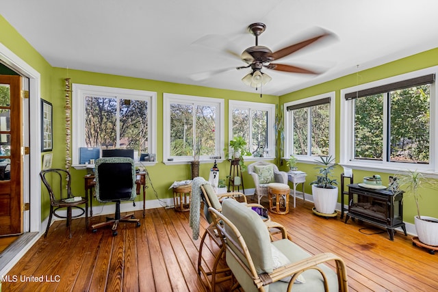 sunroom / solarium featuring ceiling fan and a wealth of natural light