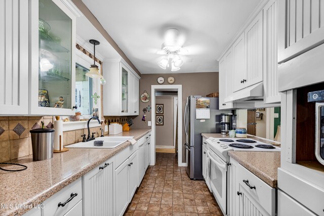 kitchen featuring decorative light fixtures, white cabinets, sink, and electric stove