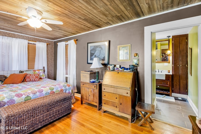 bedroom featuring crown molding, wood ceiling, light wood-type flooring, and ceiling fan