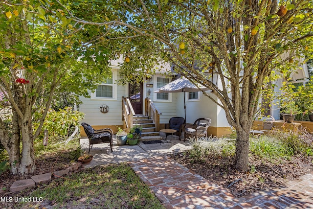 obstructed view of property with a patio