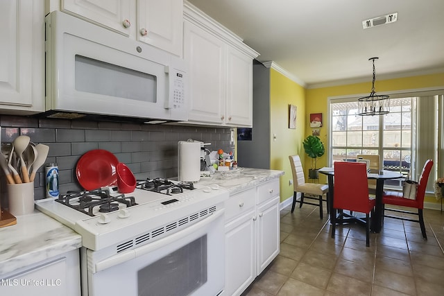 13061 Jordan Pl, Gulfport, MS 39503 - kitchen featuring white appliances, tasteful backsplash, crown molding, white cabinets, and baseboards