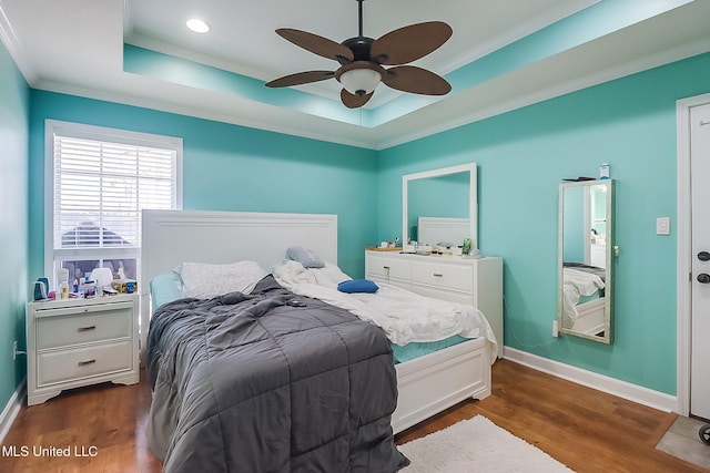 13061 Jordan Pl, Gulfport, MS 39503 - bedroom featuring a tray ceiling, crown molding, dark wood-style floors, baseboards, and recessed lighting