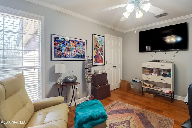 13061 Jordan Pl, Gulfport, MS 39503 - living area with ceiling fan, wood finished floors, ornamental molding, plenty of natural light, and baseboards