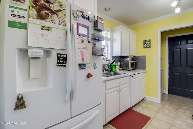 13061 Jordan Pl, Gulfport, MS 39503 - kitchen with white appliances, crown molding, white cabinets, light countertops, and decorative backsplash