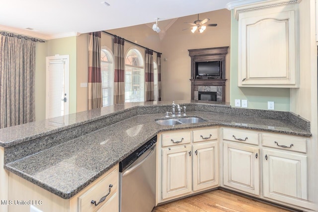 8679 Saddle Creek Dr, Olive Branch, MS 38654 - kitchen with dishwasher, ceiling fan, cream cabinetry, crown molding, and dark stone counters