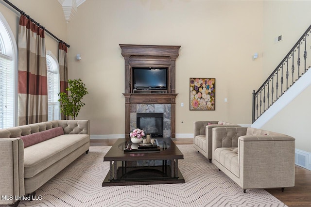 8679 Saddle Creek Dr, Olive Branch, MS 38654 - living room with a towering ceiling, wood finished floors, stairway, and a high end fireplace