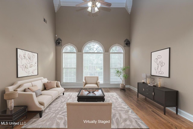 8679 Saddle Creek Dr, Olive Branch, MS 38654 - living area with a ceiling fan, a high ceiling, wood finished floors, and ornamental molding
