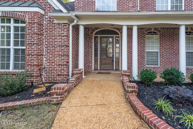8679 Saddle Creek Dr, Olive Branch, MS 38654 - view of exterior entry featuring brick siding and a porch