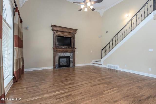 8679 Saddle Creek Dr, Olive Branch, MS 38654 - unfurnished living room featuring ornamental molding, a ceiling fan, wood finished floors, stairway, and a fireplace