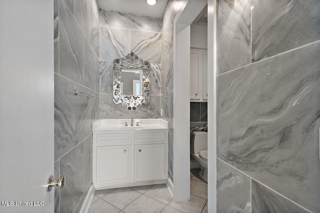 21 Breakers Ln, Ridgeland, MS 39157 - bathroom with tile patterned flooring, toilet, vanity, and tile walls