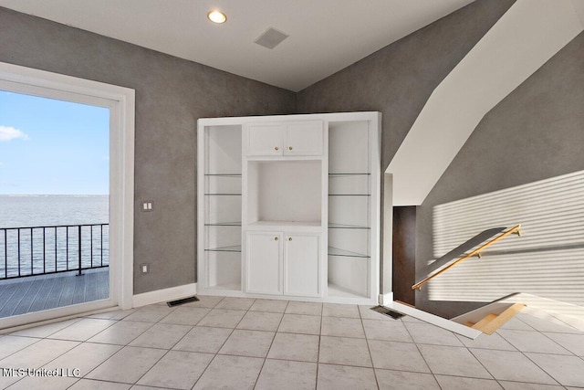 21 Breakers Ln, Ridgeland, MS 39157 - interior space with light tile patterned floors, a water view, baseboards, vaulted ceiling, and recessed lighting