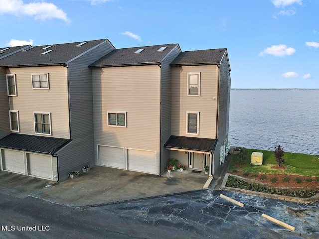 21 Breakers Ln, Ridgeland, MS 39157 - view of side of home featuring an attached garage, a water view, and driveway
