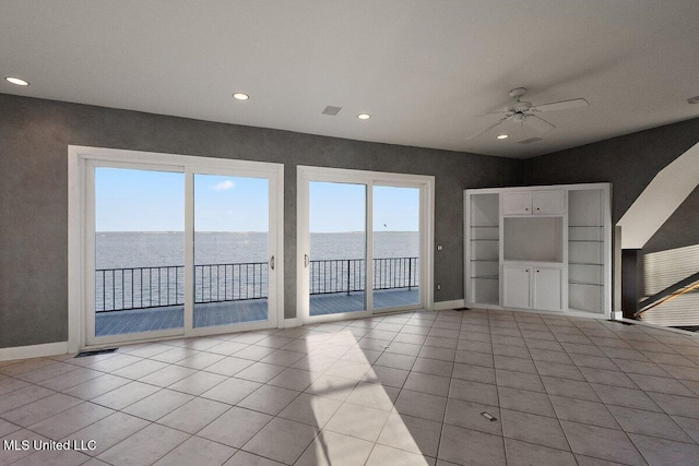 21 Breakers Ln, Ridgeland, MS 39157 - unfurnished living room featuring a ceiling fan, a water view, recessed lighting, baseboards, and tile patterned floors