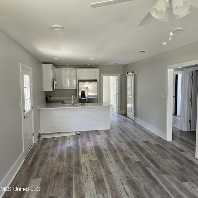 246 Bohn St, Biloxi, MS 39530 - kitchen featuring stainless steel fridge with ice dispenser, light countertops, a peninsula, and white cabinets