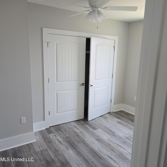 246 Bohn St, Biloxi, MS 39530 - unfurnished bedroom with wood finished floors, a closet, and ceiling fan