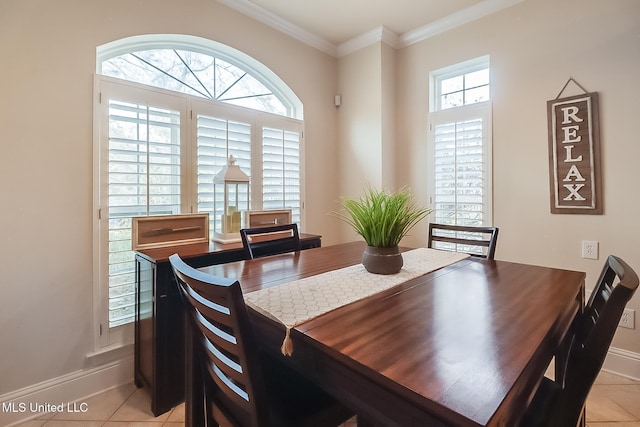 dining space with plenty of natural light, ornamental molding, and light tile patterned flooring