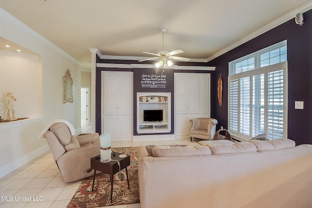 living room featuring light tile patterned floors, ceiling fan, ornamental molding, and baseboards