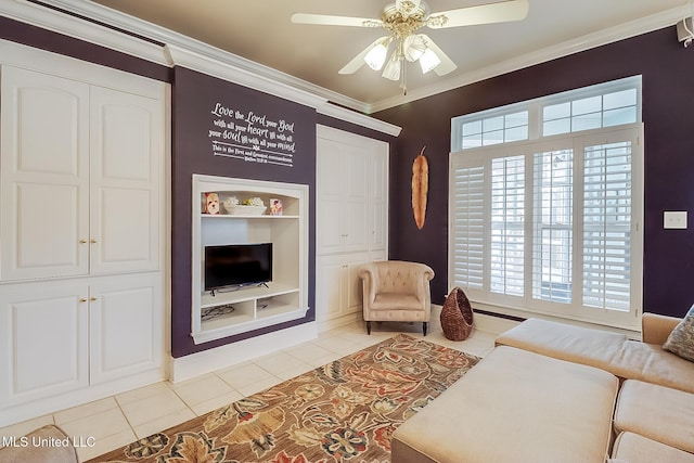 living room featuring built in features, light tile patterned flooring, crown molding, and a ceiling fan