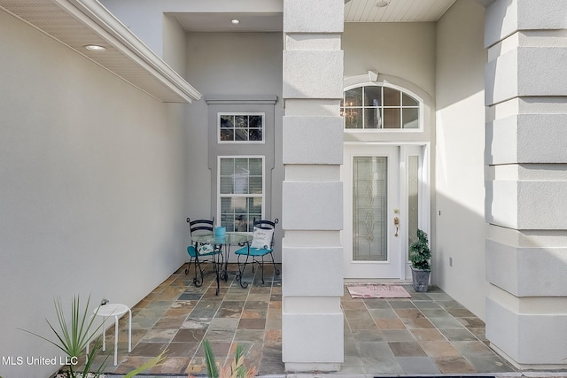 entrance to property with a patio area and stucco siding