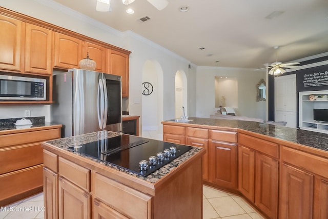 kitchen featuring light tile patterned floors, a sink, visible vents, a ceiling fan, and appliances with stainless steel finishes