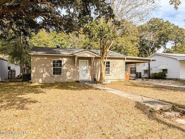 view of front facade with a carport, central AC unit, and a front lawn