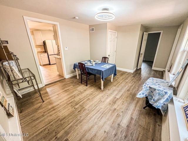 dining area with hardwood / wood-style flooring