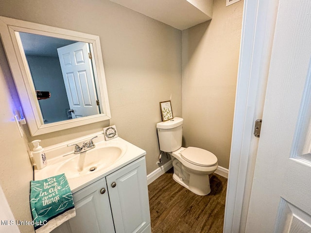 bathroom with vanity, hardwood / wood-style floors, and toilet