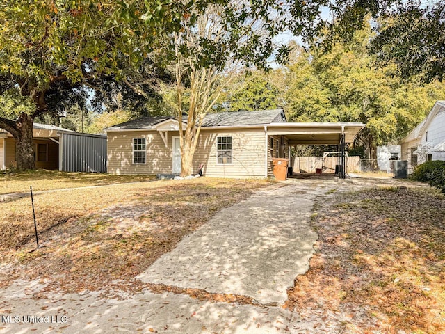 view of front of property with central AC unit and a carport