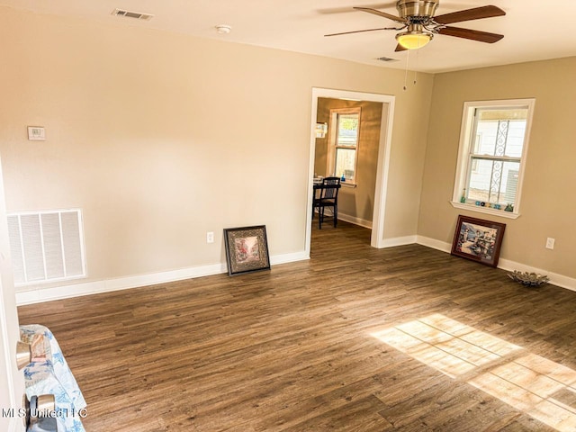 unfurnished room with ceiling fan and wood-type flooring