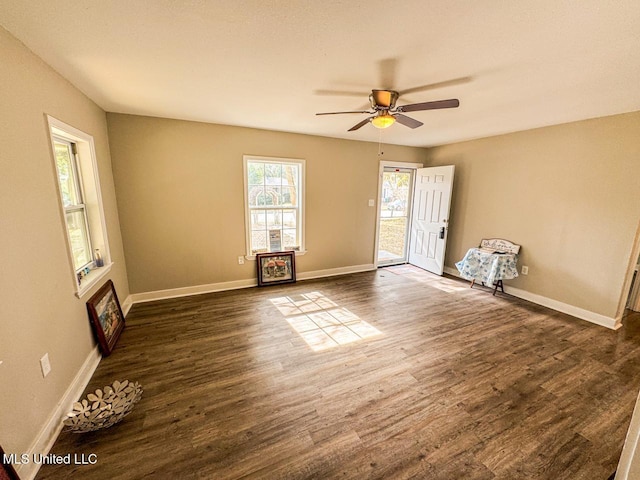 unfurnished room with ceiling fan and dark hardwood / wood-style floors