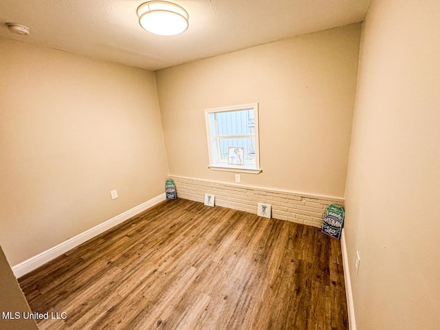 empty room with hardwood / wood-style floors