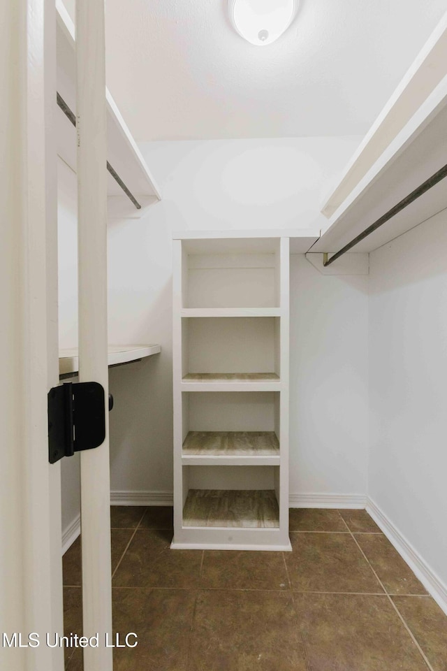 spacious closet with tile patterned flooring