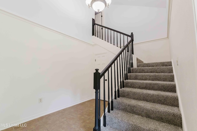 staircase featuring tile patterned flooring and baseboards
