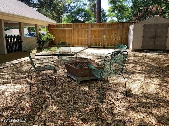 view of patio / terrace featuring an outbuilding, a shed, and fence