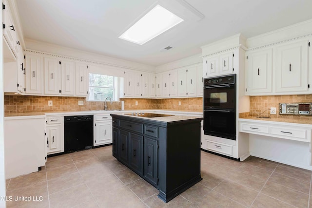 kitchen with black appliances, light countertops, and white cabinets