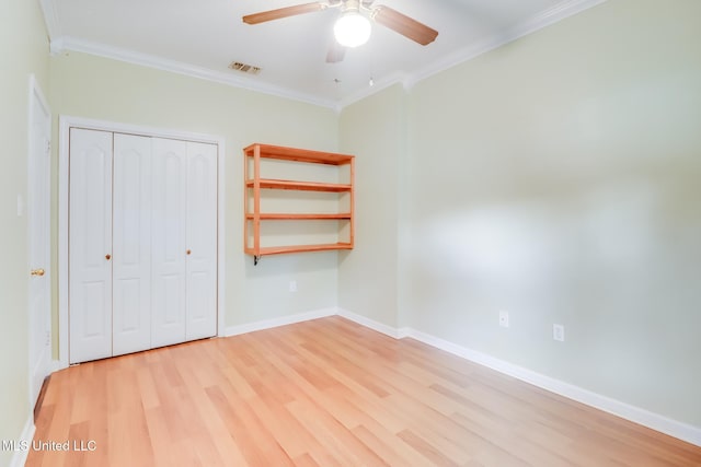 16383 Clearwater Cir, Gulfport, MS 39503 - unfurnished bedroom with crown molding, light wood-style floors, a closet, and a ceiling fan
