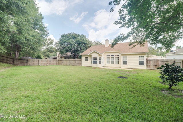 16383 Clearwater Cir, Gulfport, MS 39503 - rear view of house featuring a fenced backyard and a chimney