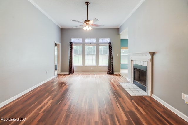 16383 Clearwater Cir, Gulfport, MS 39503 - unfurnished living room featuring crown molding, a ceiling fan, a tile fireplace, and wood finished floors