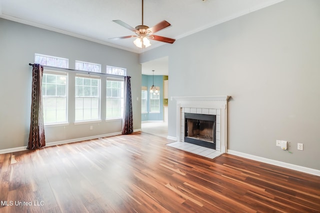 16383 Clearwater Cir, Gulfport, MS 39503 - unfurnished living room featuring ceiling fan, wood finished floors, ornamental molding, and a tile fireplace