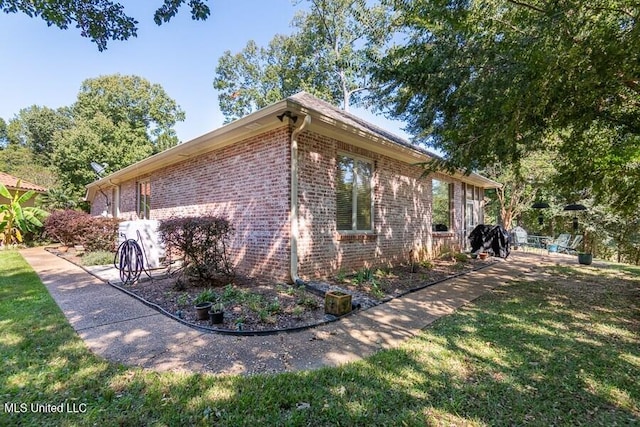 view of side of home featuring a yard