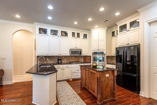 kitchen featuring sink, a center island, white cabinets, and appliances with stainless steel finishes