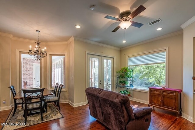 living room with french doors, ceiling fan with notable chandelier, dark hardwood / wood-style floors, and ornamental molding