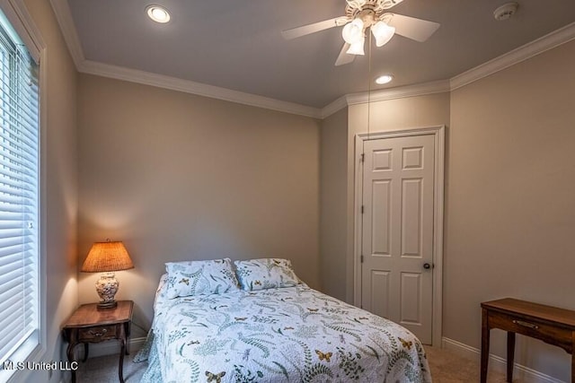 bedroom featuring ceiling fan, carpet floors, and ornamental molding