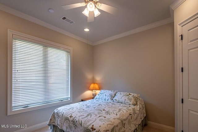 carpeted bedroom featuring ceiling fan and ornamental molding