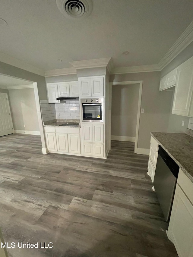 kitchen with white cabinetry, appliances with stainless steel finishes, dark stone countertops, and dark hardwood / wood-style flooring